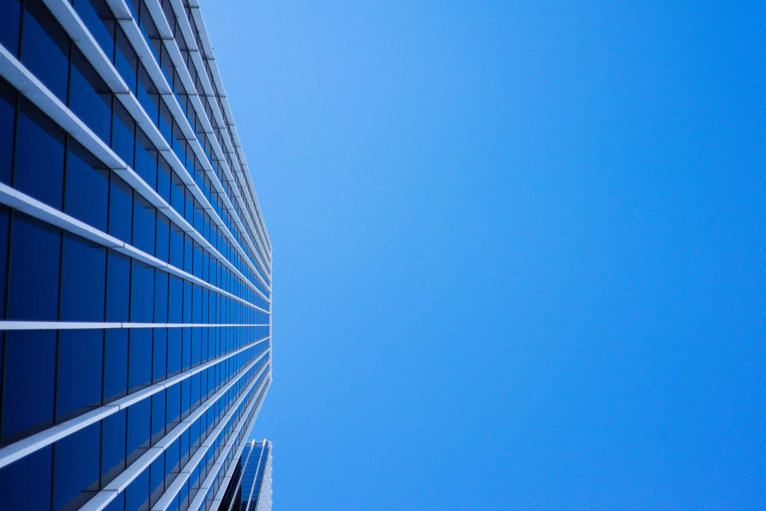 Skyscraper view from below against blue sky