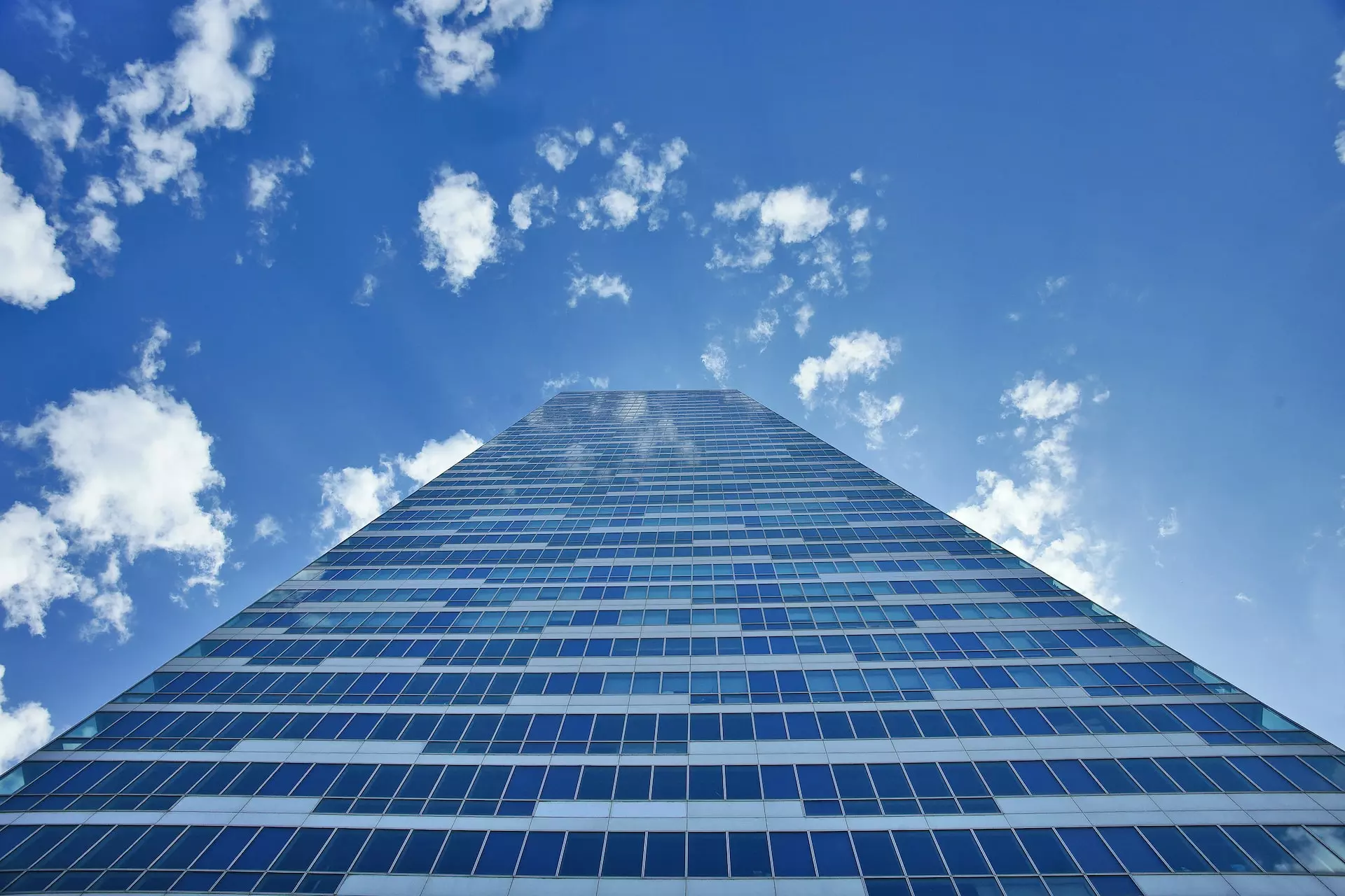 Skyscraper against blue sky viewed from below