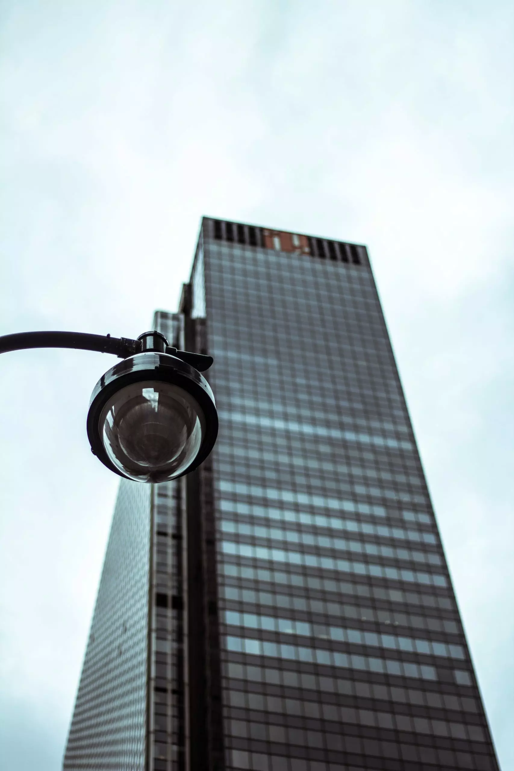 A lamppost with skyscraper in background