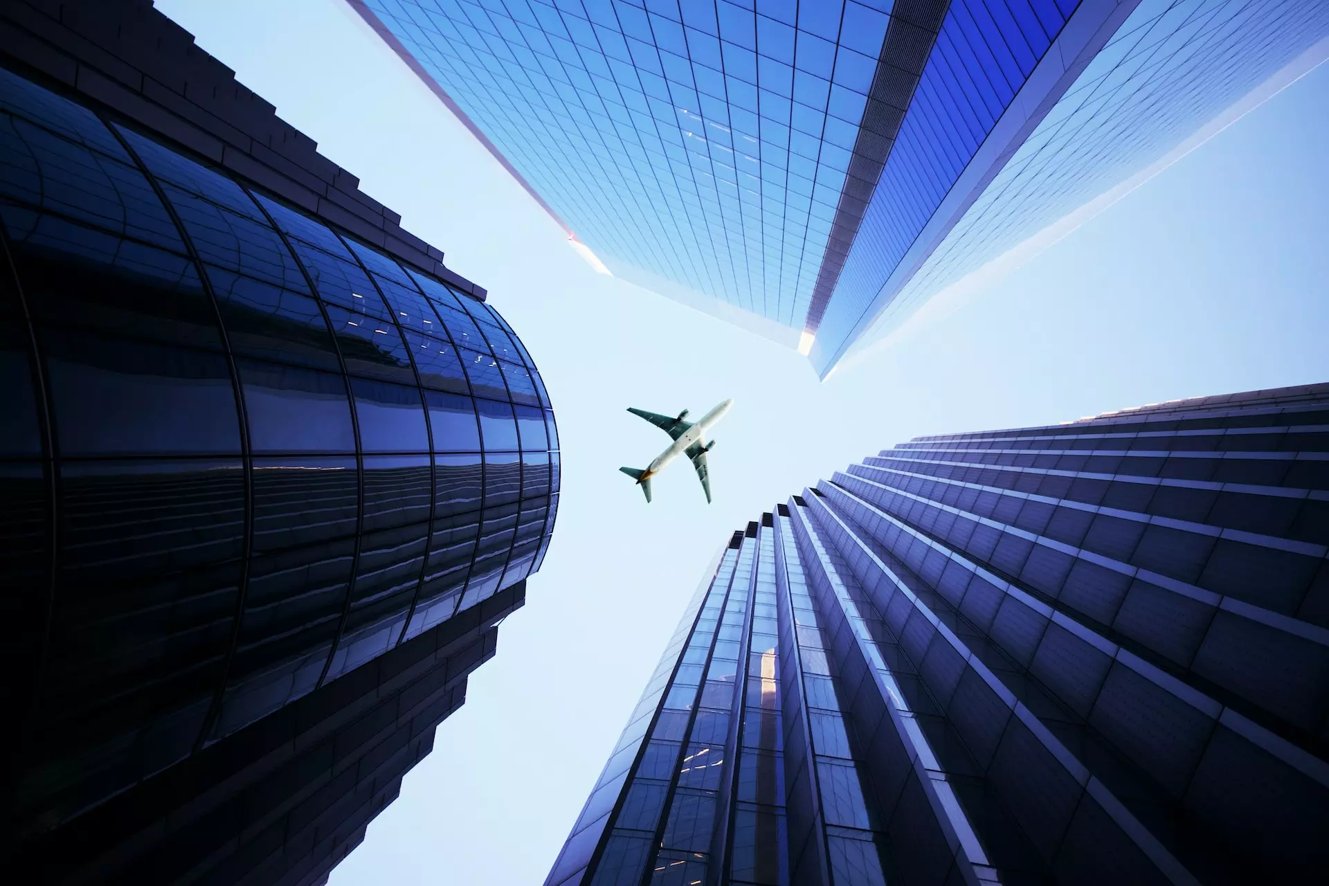 Aircraft framed by skyscrapers