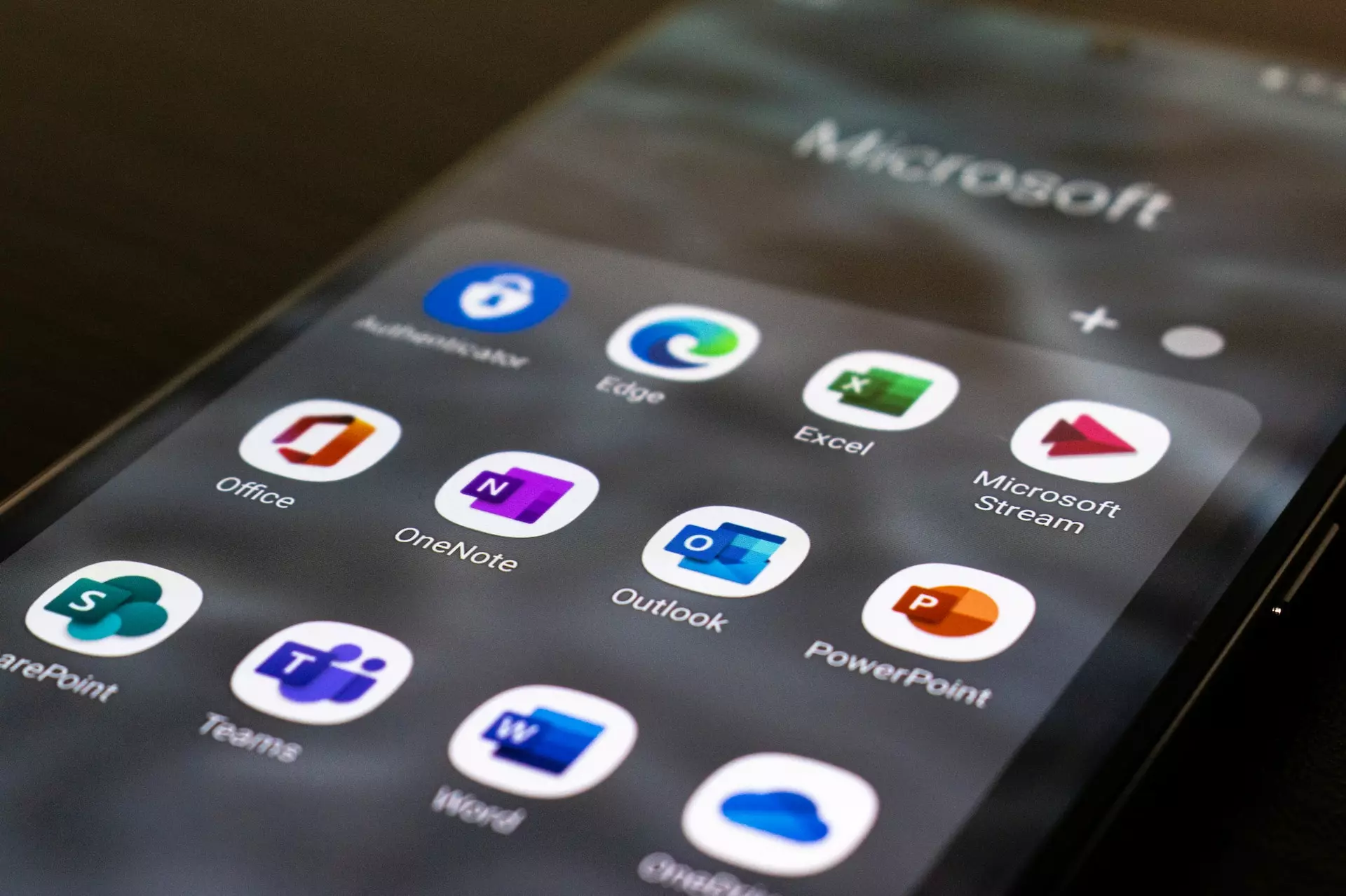 Close up view of mobile phone screen showing app menu